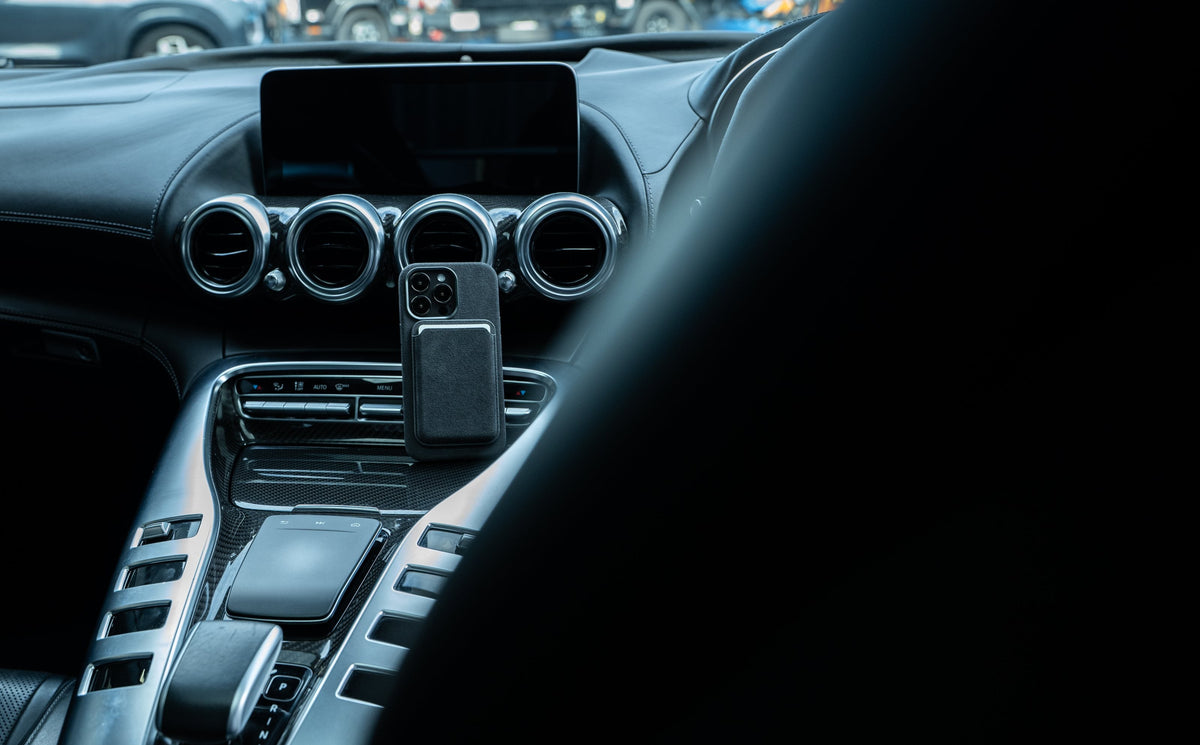 AURÊLO Graphite Alcantara iPhone case with MagSafe cardholder, mounted in an AMG interior